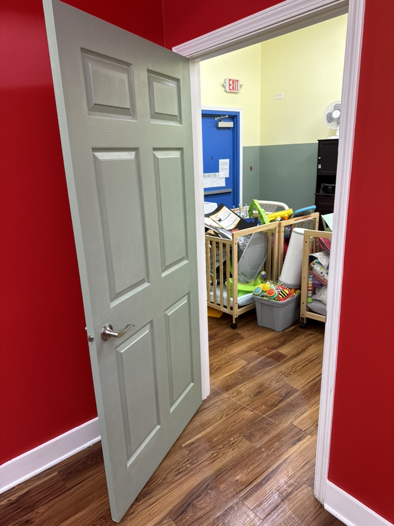 Red classroom entrance with freshly painted trim and door