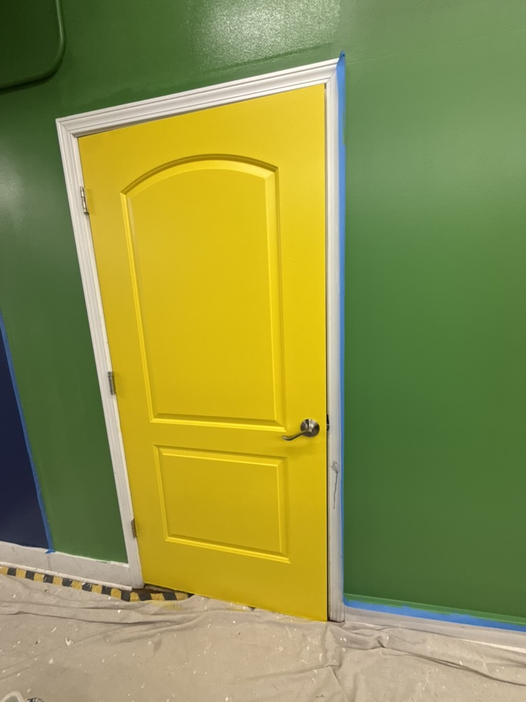 Detailed yellow door and white trim painting