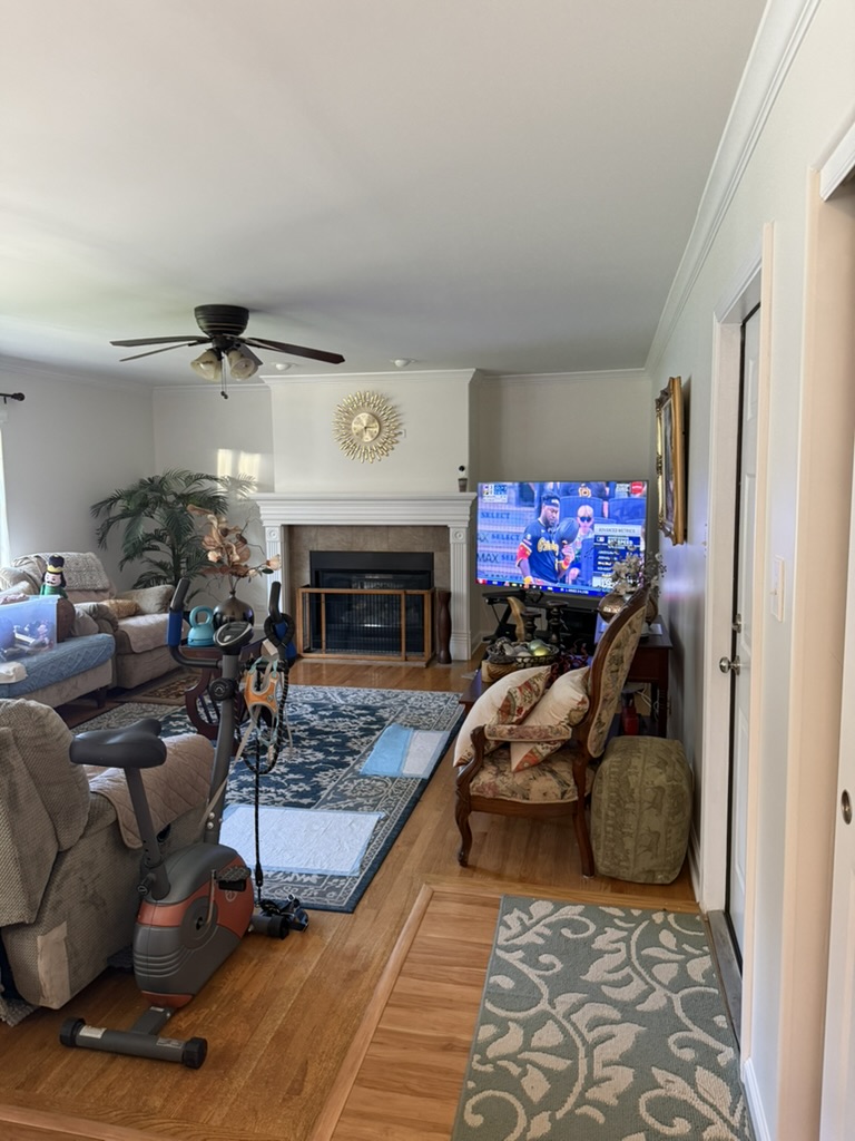 The living room after painting, with light walls and white fireplace trim