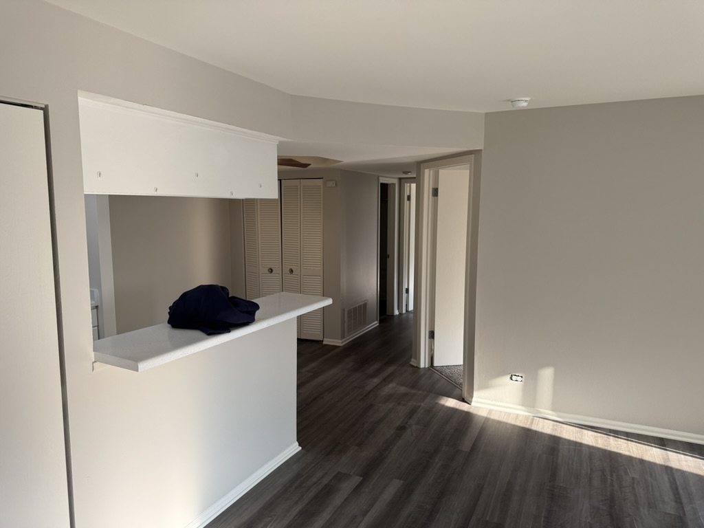 Mark apartment refresh · Classic to modern, Paint finish · Living area toward the kitchen and hallway