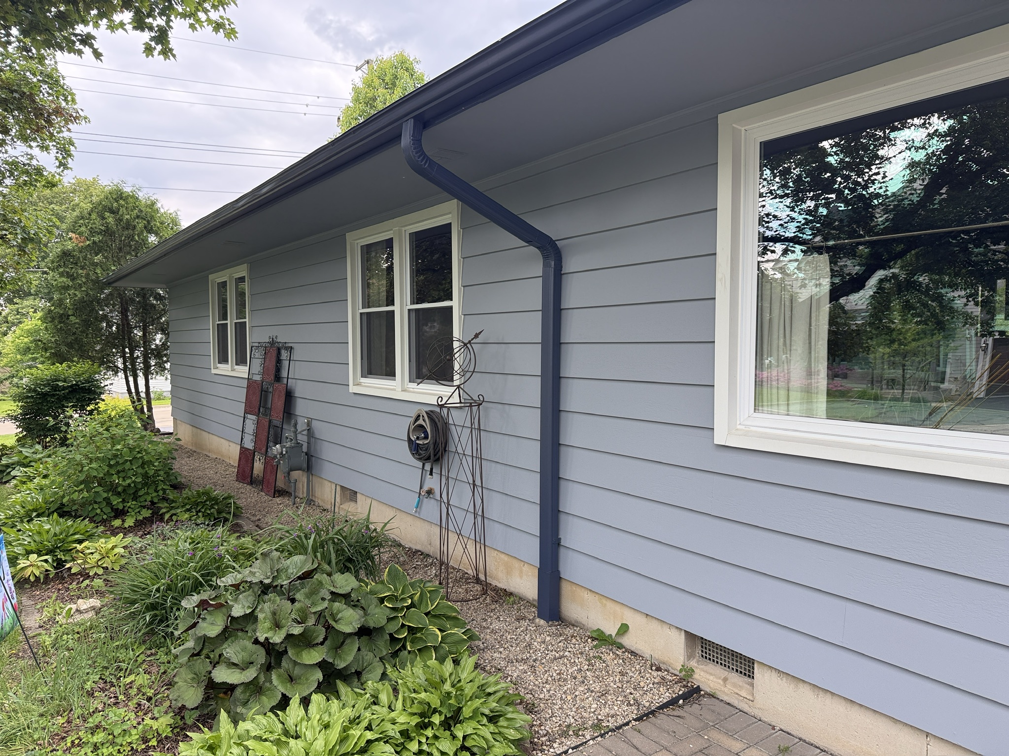 Saint Charles exterior repaint, Finished · Blue-gray siding and bright window trim